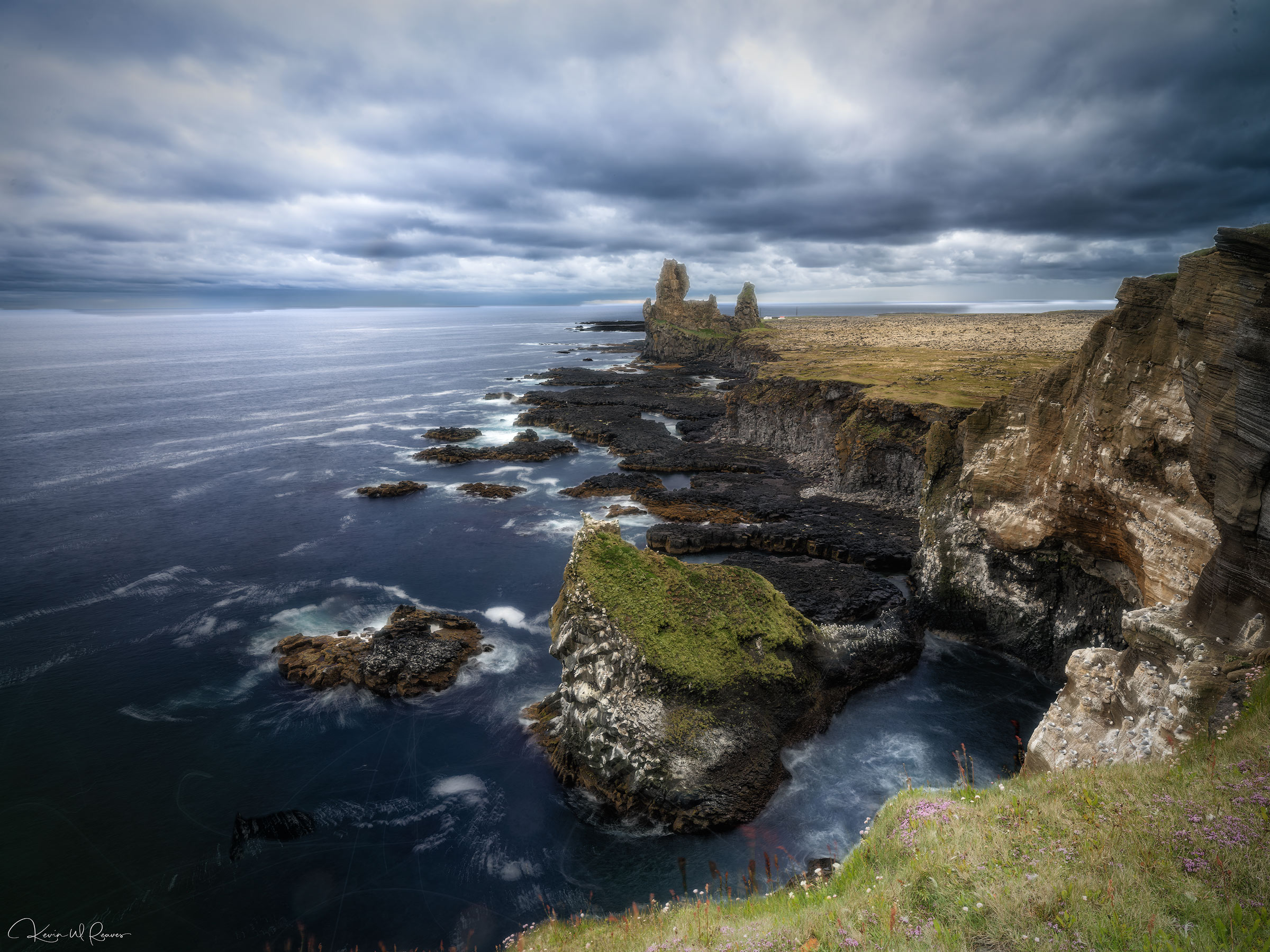 Storm Over Lóndrangar Towering volcanic sea stacks rise from the rugged coastline of the Snæfellsnes Peninsula, standing as silent sentinels...