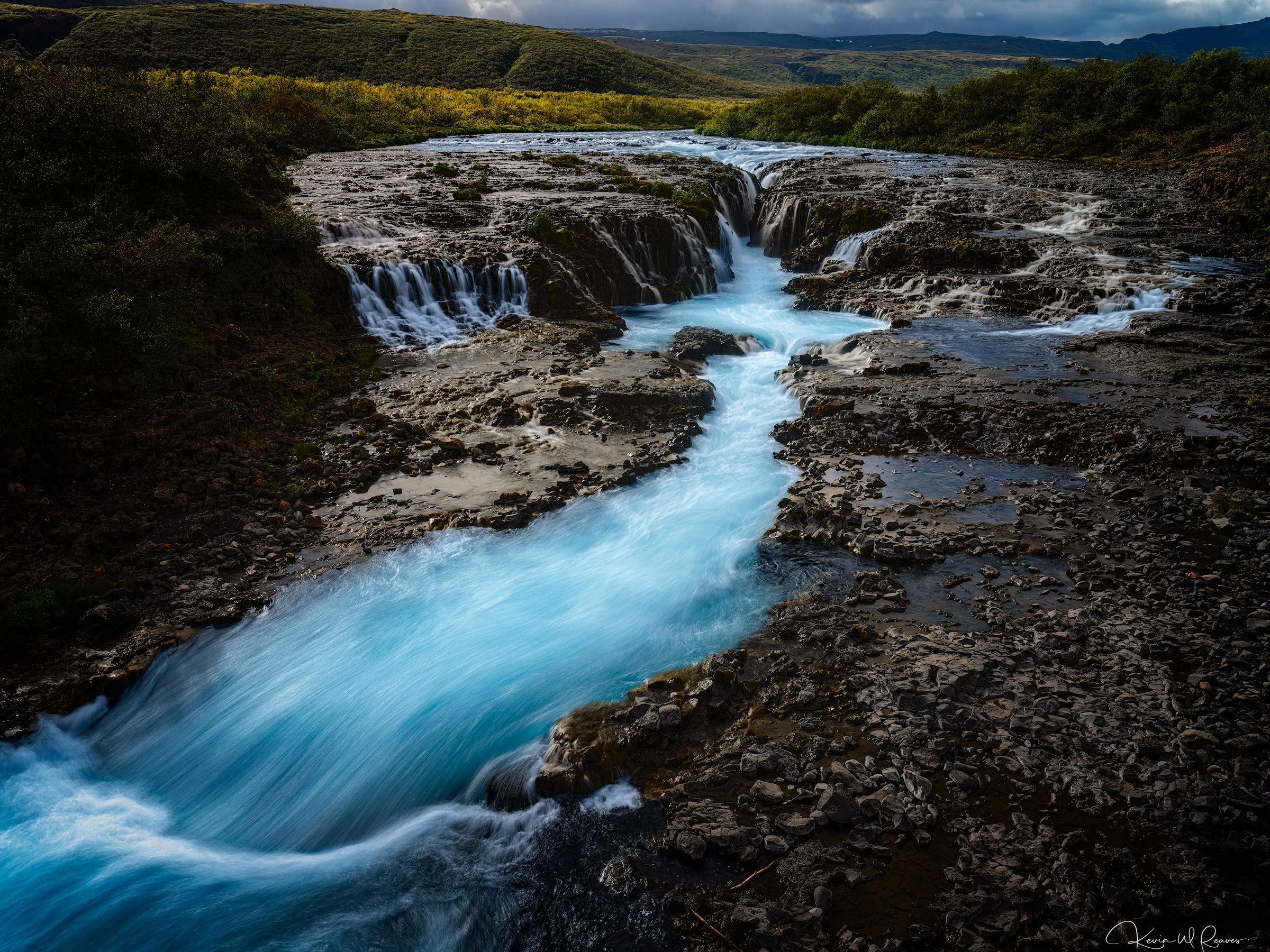 Endless Journey Brúarfoss is a study in contrast—brilliant turquoise glacial water weaving through ancient volcanic stone before...